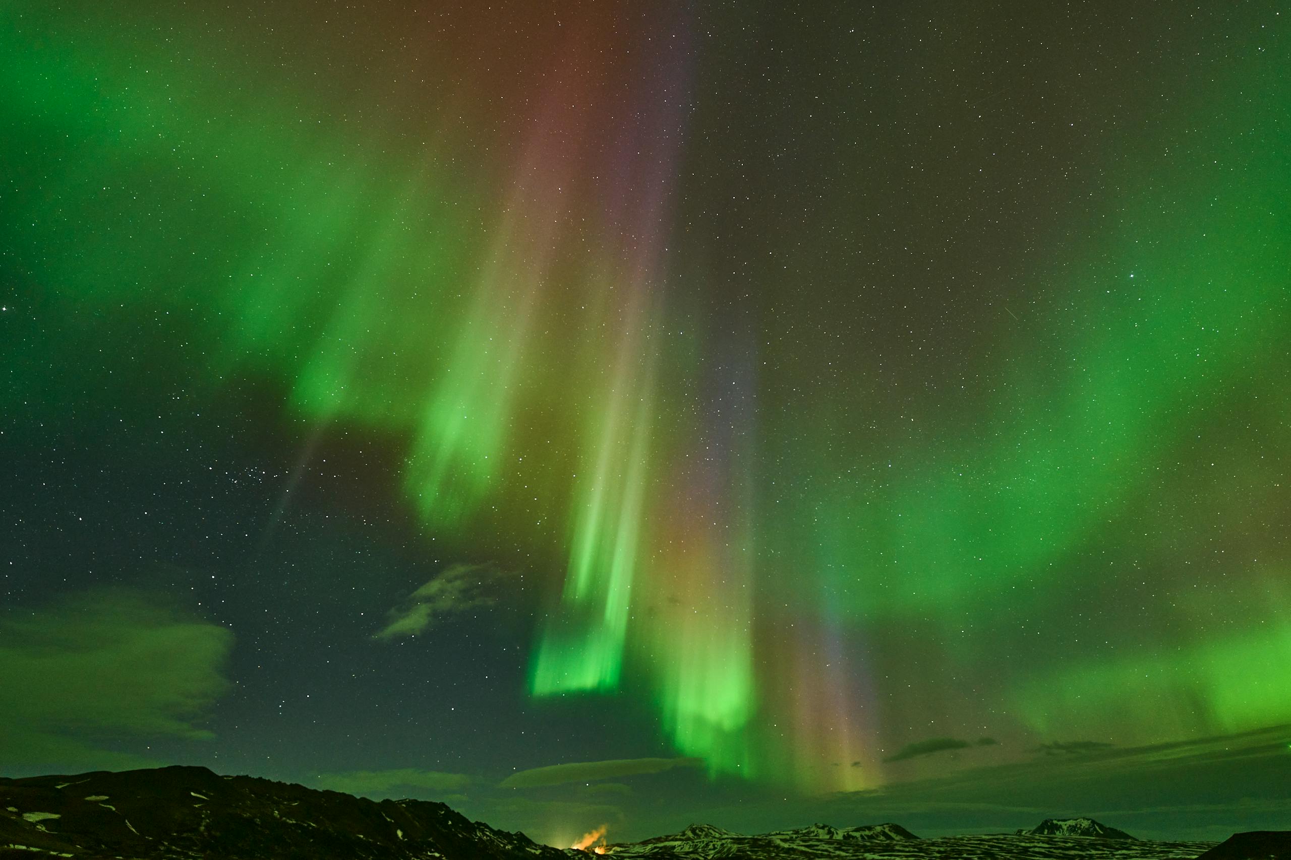 Vivid aurora borealis dancing over Rovaniemi, captivating night spectacle.